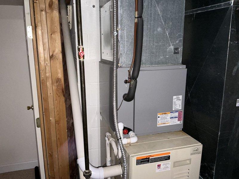 Conducted comprehensive assessment of existing Carrier furnace and HVAC system installation in basement utility area for equipment replacement estimate. Evaluated current system configuration including furnace unit, air handler, ductwork connections, electrical panel, refrigerant lines, and condensate drainage system. Documented equipment specifications, model information, and overall system condition through photographic documentation. Assessed existing duct system layout, flexible ductwork routing, PVC drain lines, and copper refrigerant line installations to determine compatibility requirements for replacement equipment. Provided detailed replacement options and recommendations based on current system configuration and installation requirements.
