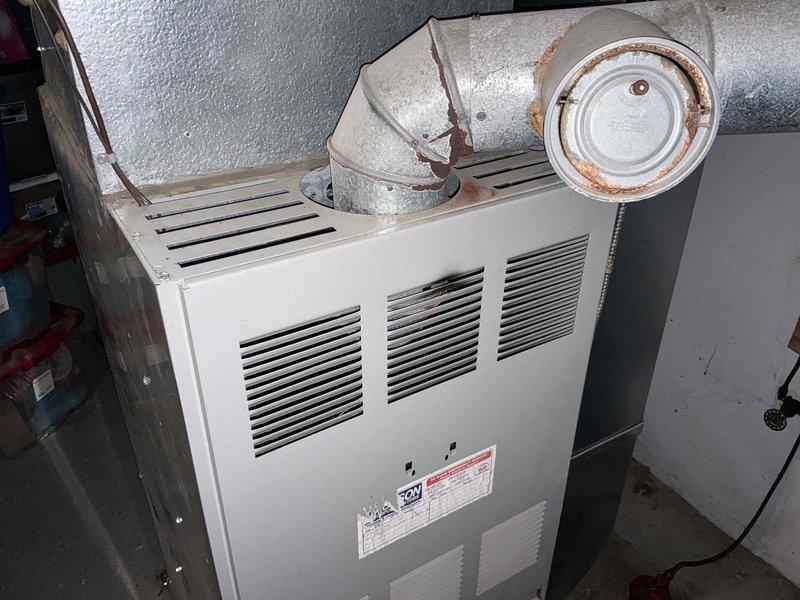 Completed estimate for replacement of 20-year-old oil furnace system with potential conversion to propane fuel source. Evaluated existing furnace unit showing significant age-related deterioration, including rust formation on ductwork connections and galvanized metal components. Provided comprehensive quote for complete system replacement to address aging equipment and fuel conversion requirements.