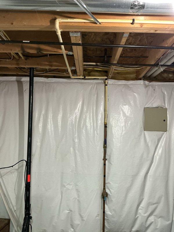 Completed installation of new sump pump system in unfinished basement area. Installed pump unit with proper discharge piping, including vertical PVC discharge line secured to wall studs with mounting clips, and connected all necessary plumbing components to ensure effective water removal from the basement space.