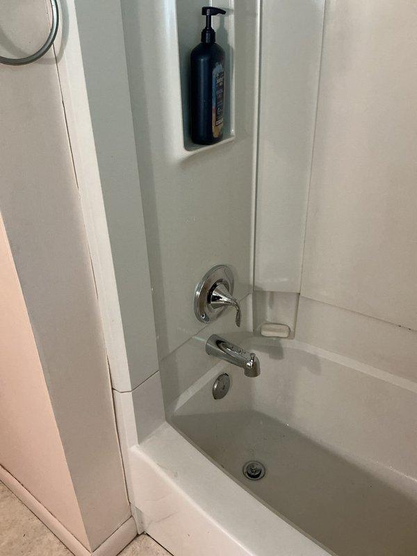 Replaced existing tub/shower valve with new Moen Eva single-handle control valve. Accessed plumbing through wall cavity, removed old valve assembly, installed new copper piping configuration with shutoff valve, and secured all components to structural framing per manufacturer specifications. Restored wall access panel and verified proper operation of shower and tub spout fixtures upon completion.
