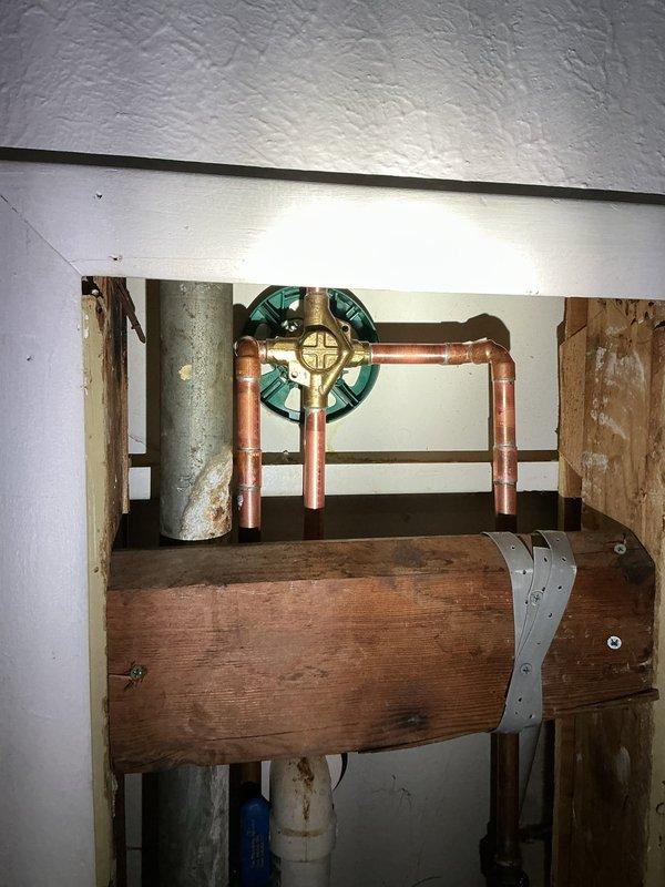 Replaced existing tub/shower valve with new Moen Eva single-handle control valve. Accessed plumbing through wall cavity, removed old valve assembly, installed new copper piping configuration with shutoff valve, and secured all components to structural framing per manufacturer specifications. Restored wall access panel and verified proper operation of shower and tub spout fixtures upon completion.