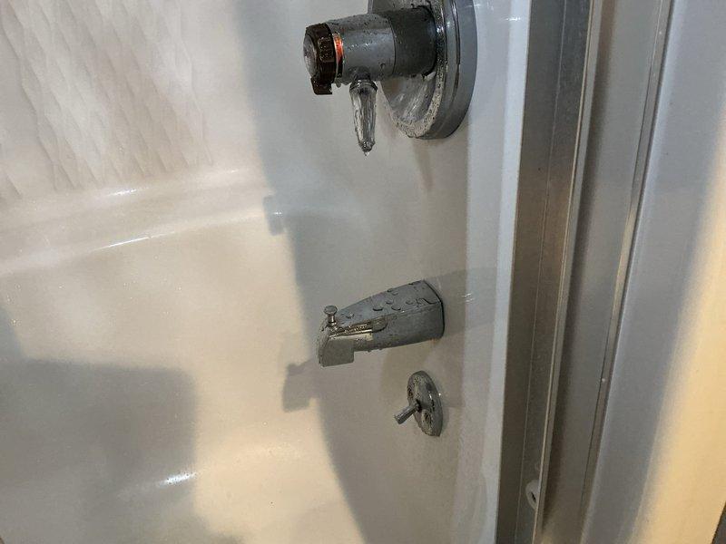 Performed pre-purchase plumbing inspection at residential property, focusing on tanked water heater and main gas line system. Conducted thorough visual examination of water heater installation, tested all connections, and performed comprehensive gas leak detection testing on main gas line and associated components to verify safe operation. Inspected bathroom plumbing fixtures including sink drain assembly with P-trap configuration and bathtub plumbing hardware, noting all fixtures functional with minor mineral deposits present on chrome components. All gas connections tested with no leaks detected, and water heater confirmed operational and properly vented.