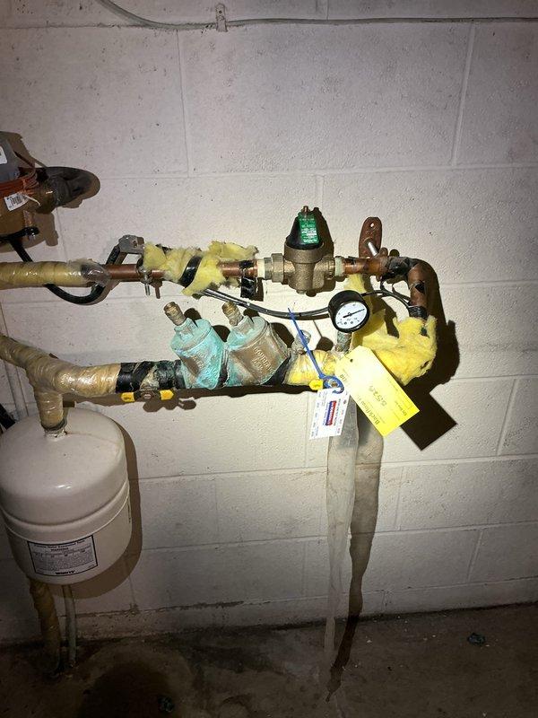 Completed backflow prevention testing on two devices located in the mechanical room. Both assemblies, identified with hazard tags #5525 and additional marking, were inspected and tested in accordance with regulations, with pressure gauges verified and all valve components checked for proper operation and compliance.