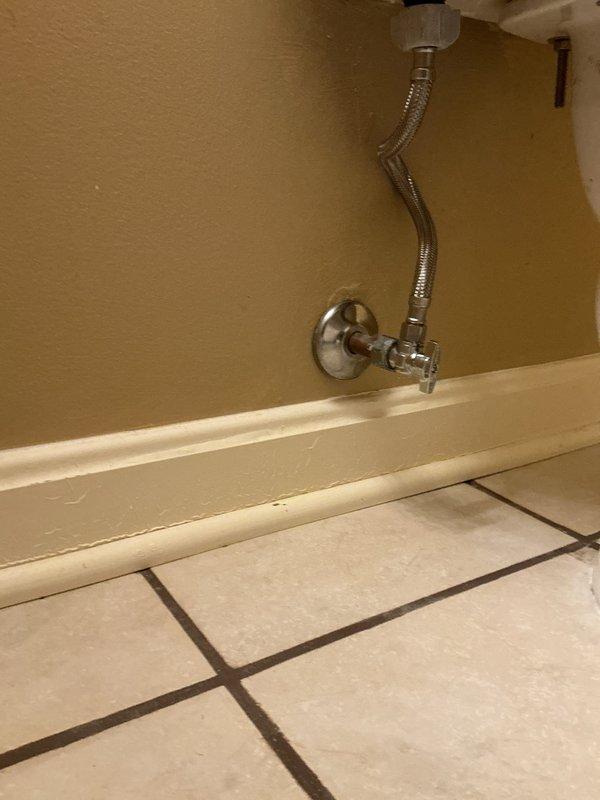 Responded to service call for upstairs toilet leaking into ceiling below. Upon arrival, performed diagnostic inspection of toilet and surrounding plumbing fixtures. Inspected toilet tank internal components including fill valve assembly with red cap, flush valve mechanism, and associated supply lines. Examined flexible braided stainless steel supply line connection from wall-mounted shut-off valve to toilet. Identified source of water leak and documented conditions with photographs. Completed diagnostic evaluation of plumbing system to determine cause of ceiling leak and necessary repairs.