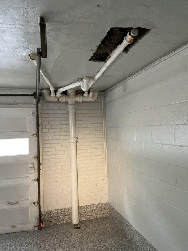 Responded to service call for slow draining in main bathroom. Performed main drain cleanout to address drainage issue and restore proper flow through the plumbing system. Inspected basement plumbing infrastructure including vertical drain lines, PVC piping configuration, and main drain access points to ensure complete clearance and verify system functionality.