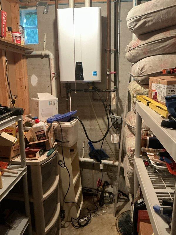 Performed routine maintenance flush on an 8-year-old Navien NFE-210S tankless water heater located in basement utility area. Descaled unit by circulating cleaning solution through the heat exchanger to remove mineral buildup and ensure optimal performance and efficiency. Verified all connections, inspected copper supply lines and isolation valves, and confirmed unit returned to proper operating condition upon completion.