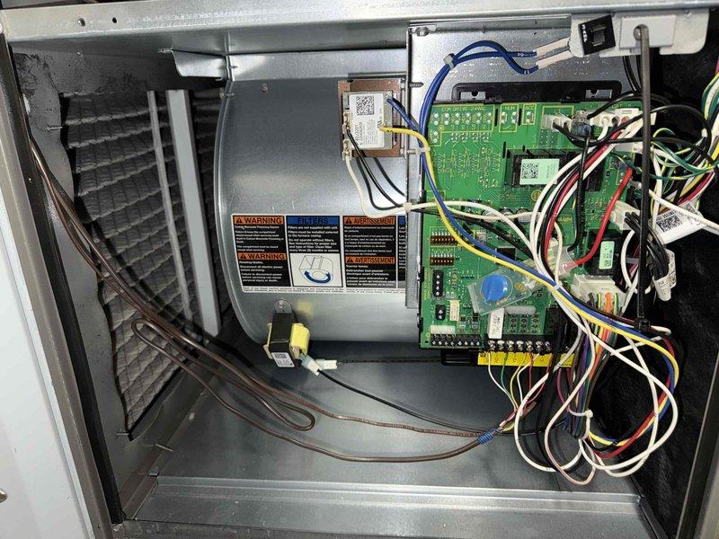 Completed routine maintenance on 15-year-old air conditioning system. Performed comprehensive inspection of all major components including blower motor assembly, control boards, electrical connections, and wiring. Verified proper operation of dual circuit boards, checked all wire connections and terminals for secure attachment, and inspected capacitor mounting. All components found to be in operational condition with no immediate repairs required.