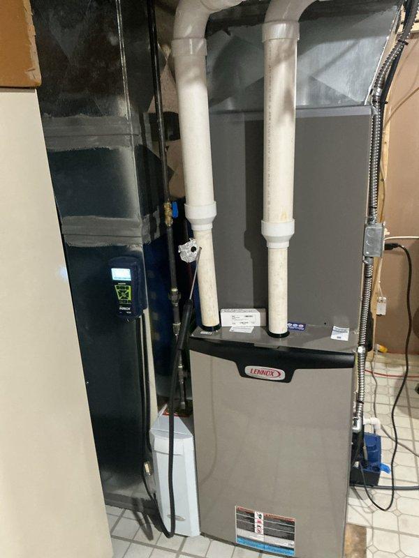 Completed comprehensive maintenance service on a 9-year-old Lennox gas furnace system. Performed thorough inspection of all major components including heat exchanger, burner assembly, and venting system. Verified proper operation of the furnace with digital temperature measurements showing supply air temperature of 128.8°F, indicating appropriate heat rise and combustion efficiency. Inspected PVC intake and exhaust venting for proper configuration and secure connections. Checked electrical connections, control wiring, and thermostat communication. Examined ductwork and transitions for proper airflow. Confirmed all safety controls and limit switches functioning correctly. System operating within manufacturer specifications with no issues identified.