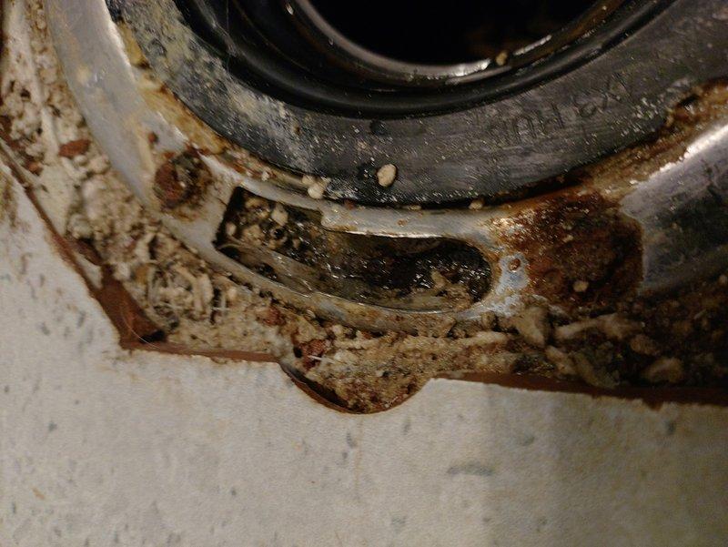 Responded to toilet instability and water leakage at the base. Upon inspection, discovered severely corroded toilet flange with extensive rust damage and mineral deposit buildup, compromising the seal integrity. Removed the existing toilet and replaced the deteriorated flange with new hardware. Installed fresh wax ring seal and properly secured the toilet to the floor using corrosion-resistant closet bolts. Verified all connections were watertight and tested for proper operation and stability.
