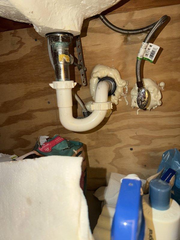 Replaced bathroom sink faucet assembly, removing old two-handle fixture with corroded chrome bases and significant mineral buildup. Installed new faucet hardware with proper connections to existing supply lines and drain assembly. Verified all connections for proper operation and absence of leaks beneath sink.