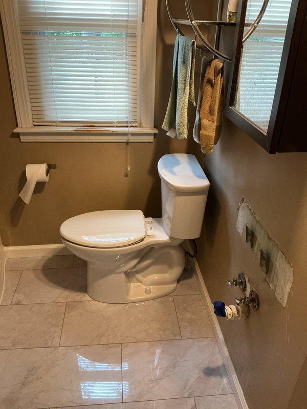 Removed and replaced an old Mansfield toilet that was leaking at the base with a new American Standard Cadet elongated bowl, right height model with slow-close seat. Replaced a corroded straight stop shut-off valve with a new chrome shut-off valve to ensure proper water supply control and prevent future leaks.