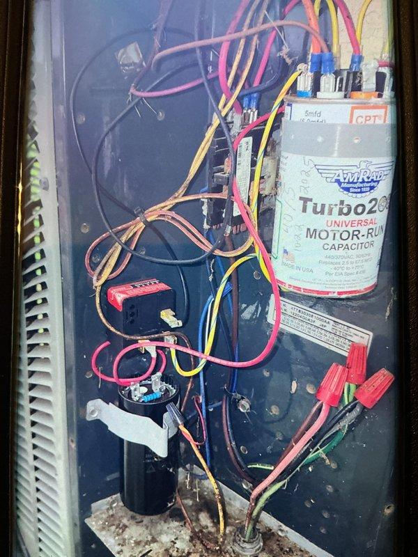 Completed MVP cooling maintenance visit on HVAC system. Performed electrical diagnostics using digital multimeter, testing capacitor functionality and electrical connections throughout the unit. Inspected Turbo200 dual run capacitor, wiring connections, and relay components; verified system operation and documented equipment condition with photos showing all electrical components functioning within normal parameters.
