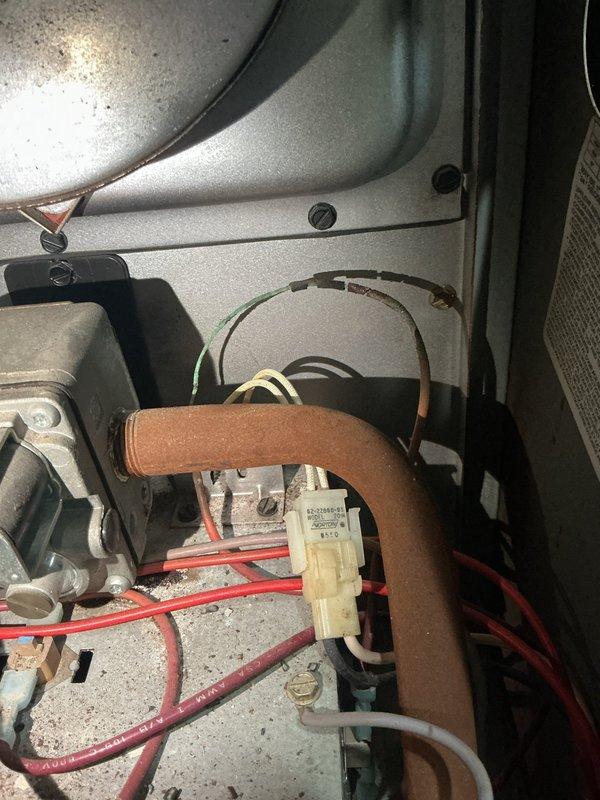 Responded to no heat call on recently installed thermostat. Upon inspection, performed diagnostic camera inspection of internal components and identified issues with electrical connections and oxidized copper tubing within the unit. Documented existing wiring configuration including relay connections and assessed condition of mechanical components to determine cause of heating system failure.