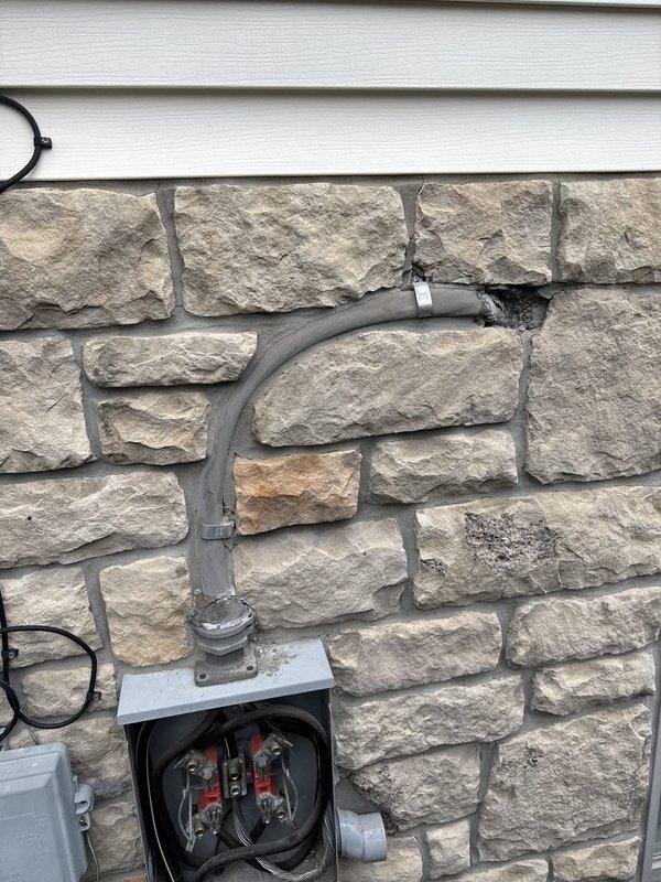 Completed installation of 22KW whole home backup generator system with approximately 20 feet of gas line and 30 feet of electrical conduit run. Installed gray PVC conduit along exterior stone veneer wall with proper mounting brackets, connected junction box with appropriately color-coded wiring, and completed all electrical terminations at the generator control panel with organized wire management using terminal blocks. Confirmed with utility company that no disconnect was required for this installation, and system was commissioned and tested for proper operation.