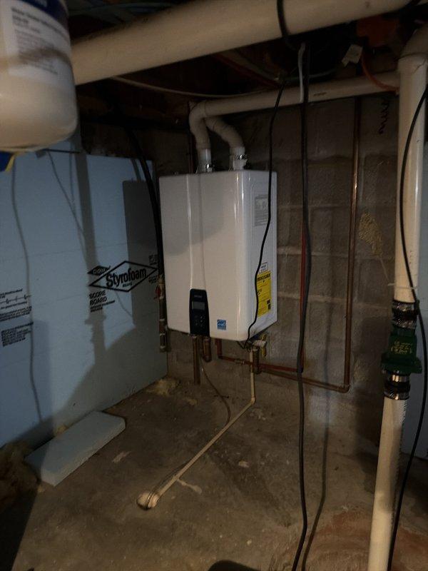 Performed scheduled maintenance descaling service on tankless water heater unit that had been in operation for approximately two years. Completed full system flush using descaling solution pumped through the heat exchanger to remove mineral buildup and calcium deposits. Connected service hoses to inlet and outlet isolation valves, circulated cleaning solution through the unit for proper dwell time, then flushed system with clean water to restore optimal flow and heating efficiency. Inspected all copper supply lines, brass valve connections, and PVC venting for proper operation and secure mounting. Unit returned to normal operation with improved performance characteristics.