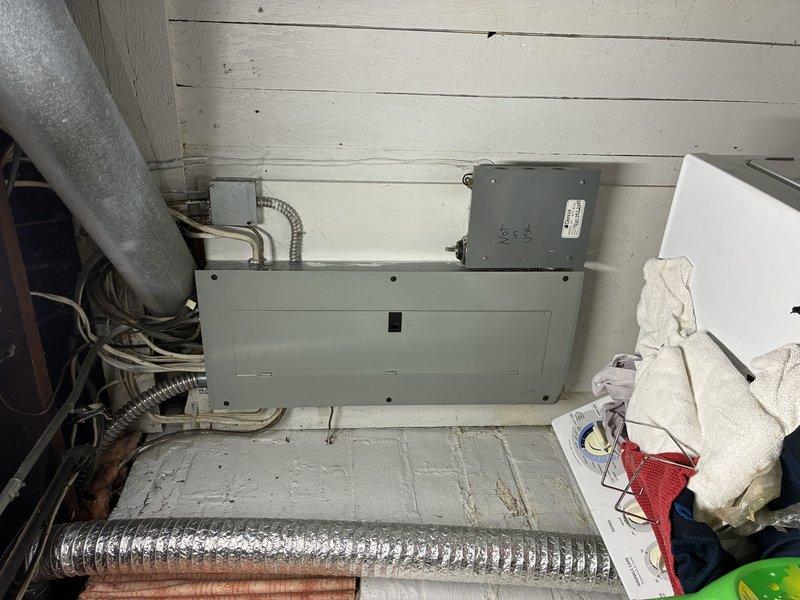 Responded to service call for non-functioning water heater that required electrical verification following previous unsuccessful repair attempt. Inspected electrical panel, junction box, and associated wiring in utility room to diagnose power supply issues affecting water heater operation. Verified electrical connections and circuit integrity to mechanical equipment, documented existing conditions with photos showing panel configuration and utility room electrical infrastructure.
