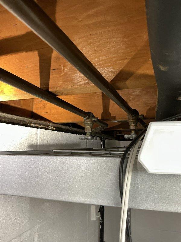 Responded to clogged basement toilet. Upon arrival, accessed the fixture and surrounding plumbing infrastructure in the basement utility area. Inspected exposed drain lines, vent piping, and structural plumbing configuration mounted to floor joists. Cleared blockage from toilet drain using appropriate augering equipment. Verified proper drainage and flush operation upon completion. Tested fixture multiple times to ensure full restoration of function with no backup or slow drainage issues remaining.