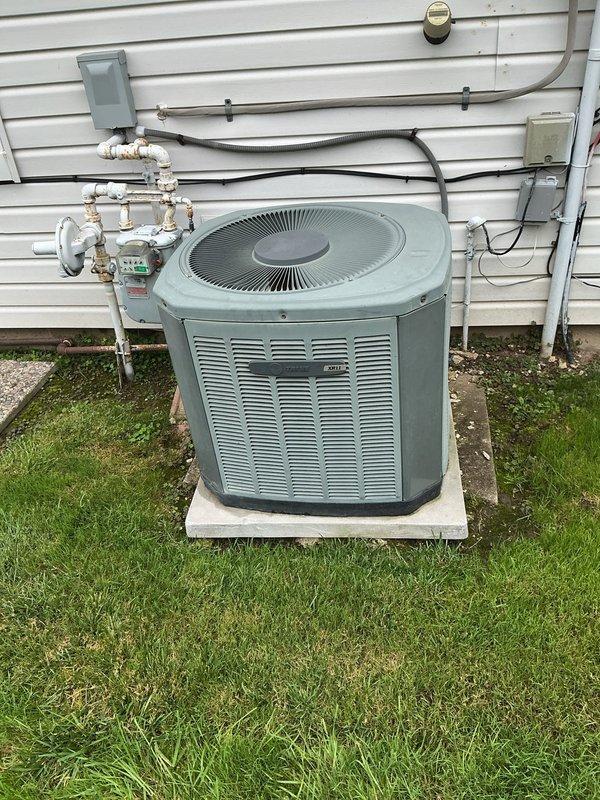 Completed comprehensive AC tune-up on 15-year-old outdoor condensing unit. Performed standard maintenance protocol including inspection of condenser coils, fan assembly, and refrigerant lines; verified electrical connections at junction box and disconnect; cleaned condenser fins showing moderate dirt accumulation and weathering; checked refrigerant line insulation and PVC drainage connections. Unit operational and performing within normal parameters for age of equipment.