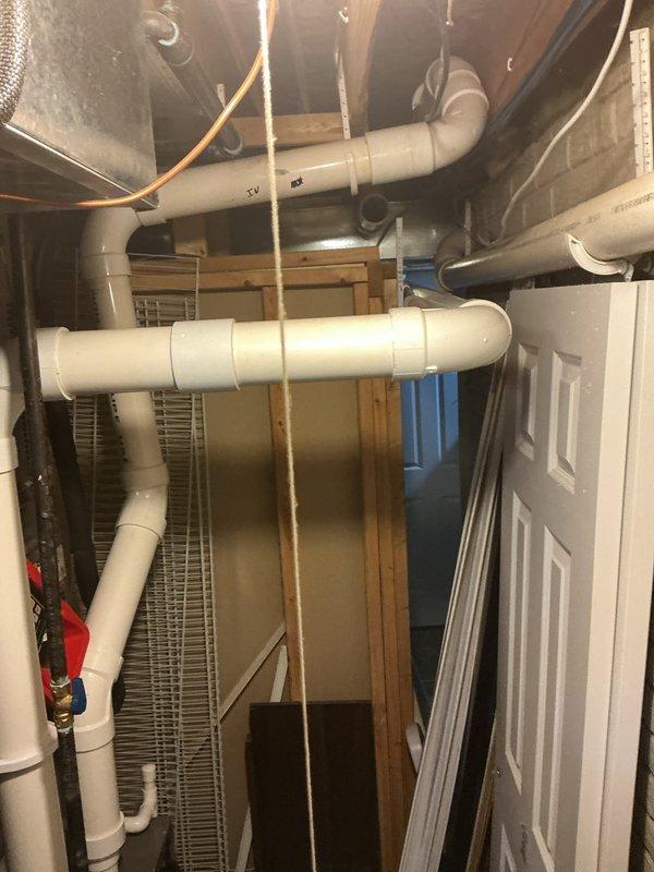 Installed new 90-degree AC bracket for complete HVAC system installation in basement utility area. Verified proper refrigerant line routing through new bracket configuration, confirmed system operational with temperature readings at 614°F during commissioning, and ensured all PVC condensate lines, copper linesets, and mounting hardware were securely installed per manufacturer specifications.