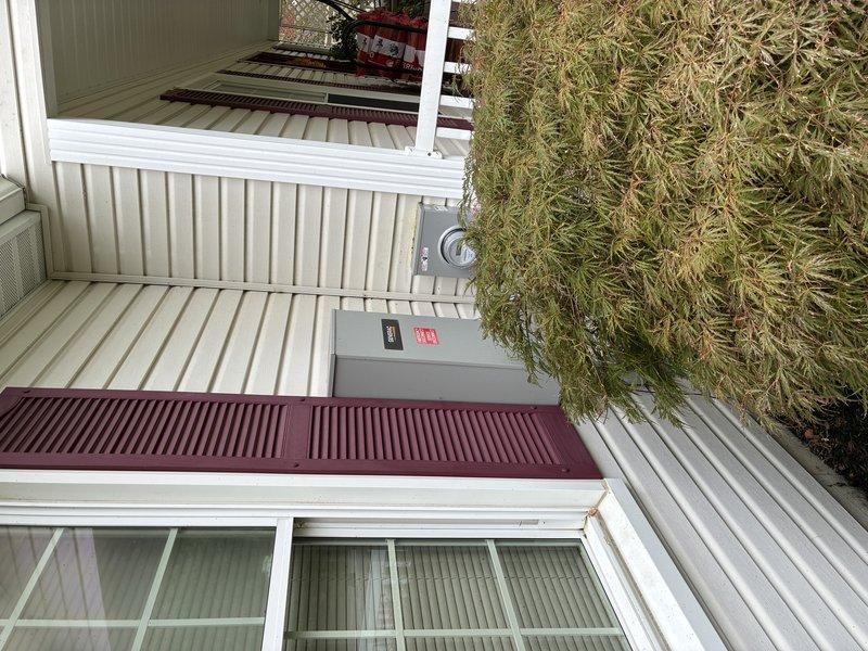 Responded to service call for 2-year-old Generac generator reported to be running rough during maintenance. Performed diagnostic inspection of generator system and evaluated installation levelness concerns. Documented current installation conditions with photographs showing generator location, electrical connections, and meter configuration on exterior wall. Provided estimate for releveling generator unit to proper specifications.