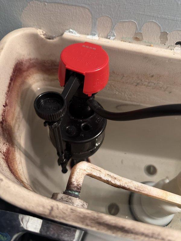Installed a pressure reducing valve with ball valve assembly after the water meter, including necessary brass fittings and couplings to regulate incoming water pressure. Replaced the deteriorated fill valve and corroded supply line on the first-floor toilet, addressing significant rust buildup and mineral deposits within the tank. All components were tested for proper operation and leak-free connections upon completion.