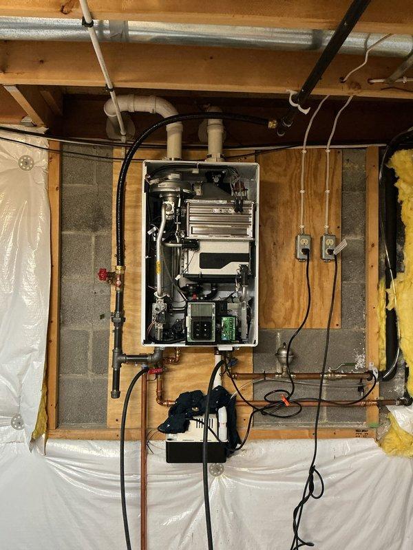 Performed preventative maintenance descaling service on wall-mounted Navien tankless water heater unit. Flushed system using descaling solution to remove mineral buildup from heat exchanger, inspected and cleaned inlet filter screen which showed moderate sediment accumulation, and verified all connections and operational components for proper function upon completion.