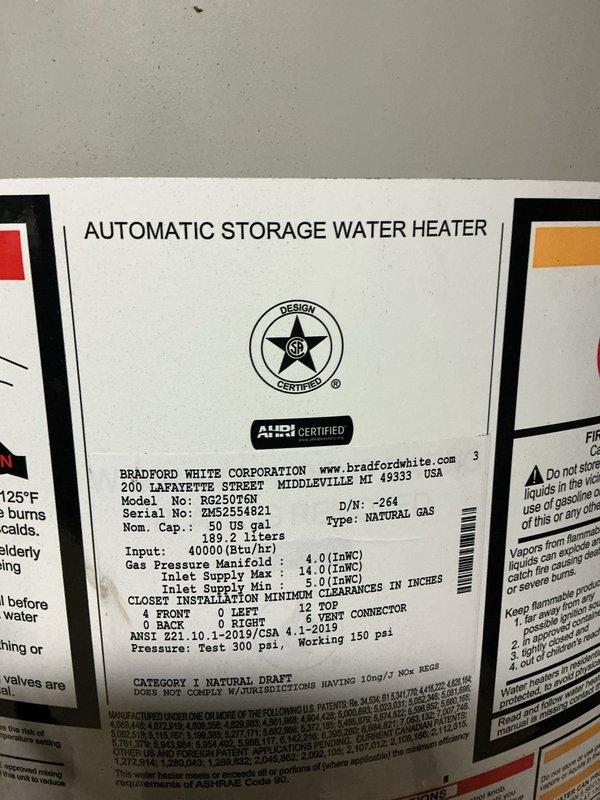Responded to service call for water softener emitting foul odor. Upon arrival, inspected recently installed water softening system and associated plumbing connections. Evaluated Bradford White 50-gallon natural gas water heater and surrounding copper piping with brass fittings to determine source of odor complaint. Documented equipment specifications and installation configuration for diagnostic purposes.