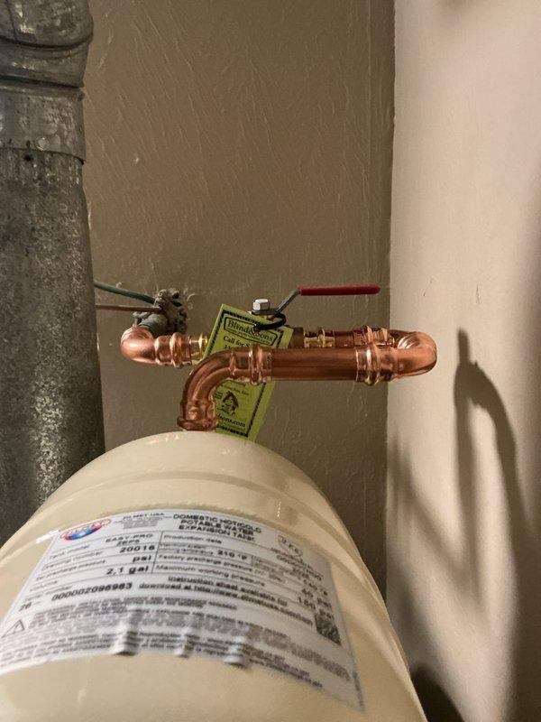 Removed existing water heater and installed new 40-gallon Bradford White residential water heater. Upgraded installation to current code compliance by installing new ball valve shut-off and thermal expansion tank. Connected copper supply lines and verified proper venting with existing flue system. Confirmed unit bonding and shut-off valve met code requirements. Completed all plumbing connections, tested system for proper operation and leak-free performance. Hauled away old water heater from premises. Registered new unit with manufacturer for 6-year warranty coverage.