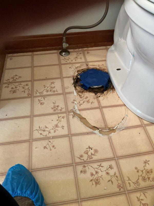 Responded to a service call for toilet issues with visible water damage and floor staining. Upon inspection, discovered significant leakage around the toilet base and floor drain area, evidenced by extensive brown discoloration and rust-colored staining on the ceramic tile flooring. Removed and reset the toilet to address the leak source, replacing the wax ring seal and toilet mounting bolts. Inspected the floor flange for damage and confirmed proper alignment and secure attachment to the subfloor. Reconnected the chrome water supply line with new compression fittings to ensure a watertight seal. Tested the toilet for proper operation, checking for leaks at the base and supply connection. Documented the existing floor damage and staining for customer records, noting that tile cleaning or replacement would be recommended to address cosmetic concerns from the previous water intrusion.