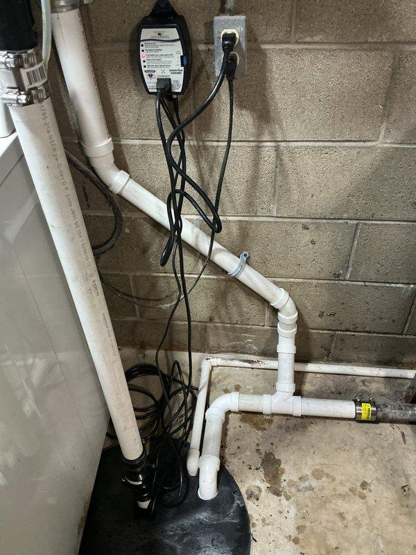 Completed full sump pump system upgrade by removing and disposing of existing unit and installing higher-rated Zoeller sump pump with new basin lid featuring custom-drilled openings for utility sink discharge, HVAC condensate line, and pump discharge pipe. Installed new PVC discharge piping with check valve to prevent backflow, added wall-secured standpipe for laundry discharge line with accessible termination point allowing homeowner to install screening for lint and debris capture, and completed all electrical connections with proper cord management.