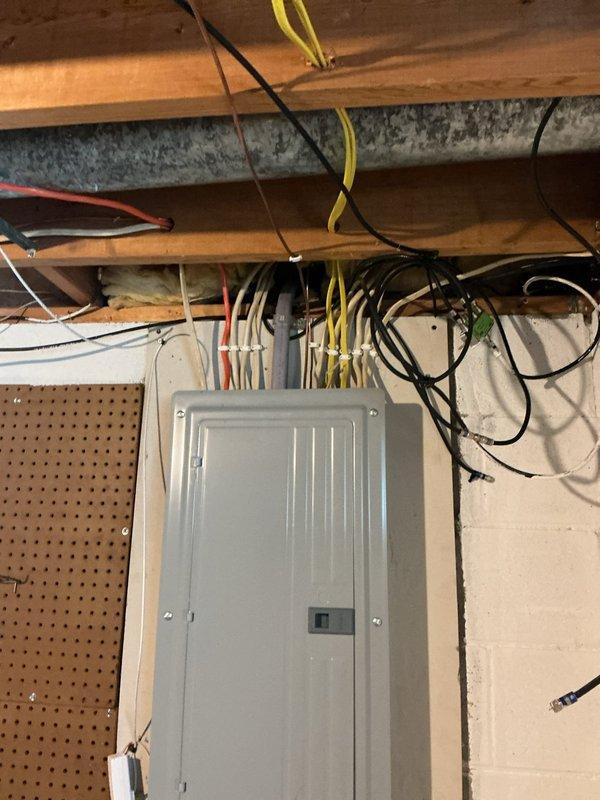 Replaced damaged exterior electrical conduit running from meter box to main electrical panel. Installed new PVC conduit pipe with proper couplings and mounting straps, then pulled and terminated new circuit wiring to restore safe electrical service to the panel.