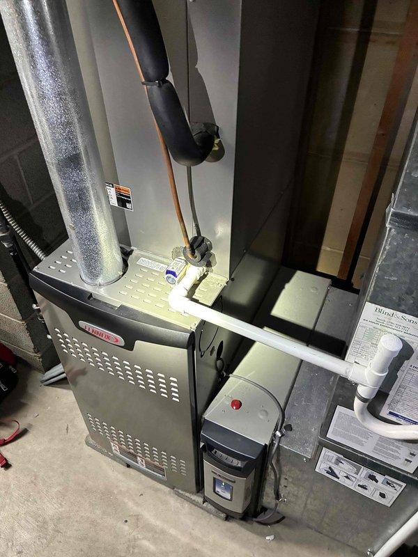 Completed comprehensive cooling maintenance on a 7-year-old air conditioning system. Performed temperature diagnostics on supply ductwork, recording 63.7°F at the plenum, indicating proper system operation and adequate cooling output. Inspected condenser coil, evaporator assembly, refrigerant lines with insulation, and all associated HVAC components including furnace cabinet and humidifier unit. System operating within normal parameters with no deficiencies noted.
