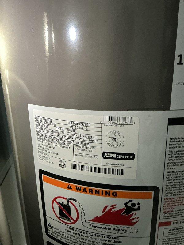 Responded to service call for natural gas water heater replacement quote. Upon arrival, inspected existing water heater unit located in basement utility area. Documented current equipment, which was manufactured in April 2017 and showed standard safety labeling including fire and explosion hazard warnings for flammable vapor ignition. Photographed installation area including concrete floor conditions, exposed floor joists, existing plumbing connections, and floor drain access point. Assessed utility connections including gas line, water supply lines, and venting requirements for replacement specifications. Provided detailed quote for complete water heater replacement with proper code-compliant installation.