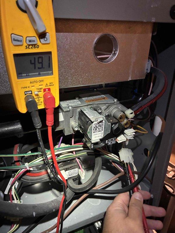 Completed comprehensive MVP maintenance on a 5-year-old gas furnace system. Performed thorough inspection of all heating components including gas valve assembly, ignition system, and control board. Verified proper electrical connections and measured voltage readings using calibration equipment, confirming system operating within manufacturer specifications at 49.7V. Inspected and tested integrated furnace control board, verifying all terminal connections, safety circuits, and outdoor communication interfaces functioning correctly. Examined gas valve control module and associated wiring harnesses for proper installation and secure connections. All components showed normal wear consistent with equipment age with no signs of deterioration or damage requiring immediate attention. System tested and confirmed operational.