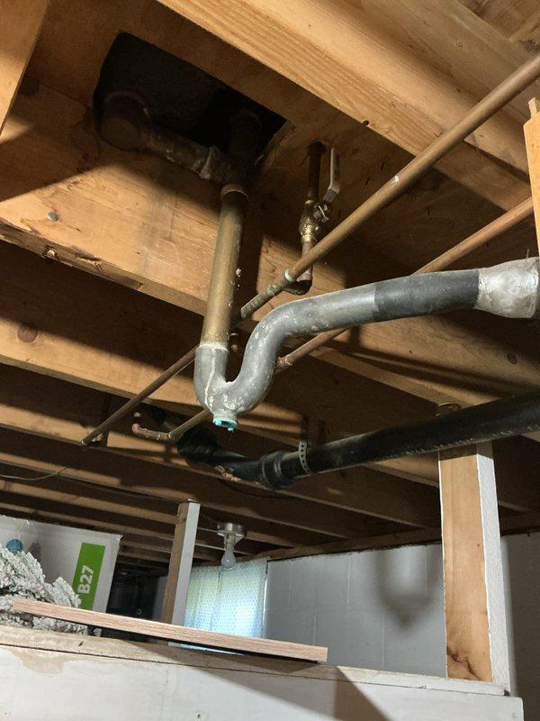 Responded to complaint of foul odor emanating from shower drain in 66-year-old residence with clay piping system. Accessed crawl space beneath bathroom to inspect drain assembly and trap configuration. Upon investigation, identified aging P-trap and drain connections showing signs of deterioration consistent with original clay pipe infrastructure. Documented existing plumbing conditions including galvanized and copper supply lines, drain trap assembly, and exposed joists for assessment. Photographed drainage system components to verify trap integrity and identify potential sources of sewer gas infiltration that could be causing the reported odor issue.