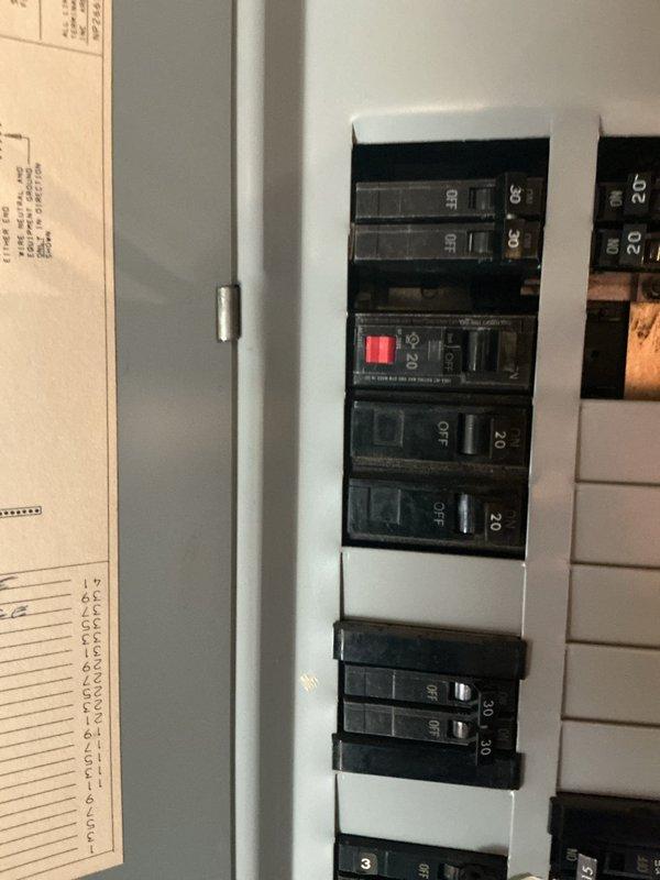 Relocated dishwasher circuit wiring from front of cabinets to proper position behind dishwasher location. Installed new outlet at dishwasher location and reconnected disposal to existing old work box. Added GFCI protection at electrical panel to bring dishwasher/disposal circuit up to current code requirements.