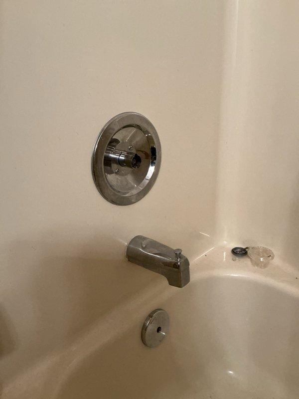 Responded to service call for non-functioning shower in bathtub/shower combination unit. Performed diagnostic inspection of chrome shower valve control, tub spout, and associated plumbing fixtures. Created wall access opening to expose concealed plumbing lines and drainage system behind fiberglass surround for proper assessment and repair of shower malfunction.