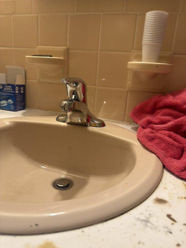 Replaced hall bathroom lavatory faucet with new chrome single-handle unit and installed new angle stops for improved water shutoff capability. Repaired drain assembly at wall connection, including installation of new P-trap and drain components to ensure proper drainage and eliminate leaks. All plumbing connections were tested and verified operational upon completion.