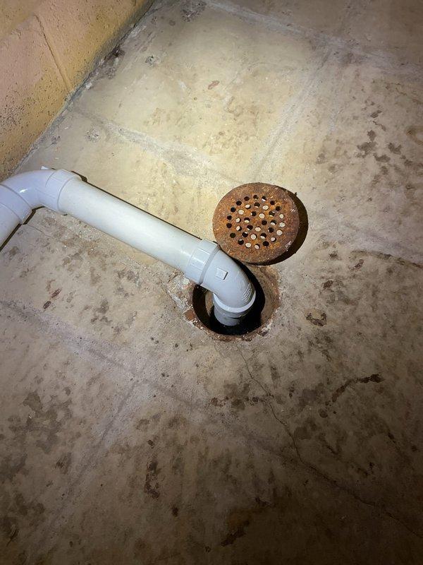 Completed full plumbing installation for new washer and slop sink location in basement utility area. Removed existing copper water supply lines and capped appropriately. Teed off existing 3/4" water lines near water heater and ran new 1/2" copper supply lines to new location, installing hose bibs for washer connection and shut-off valves for deck-mounted faucet along sink wall. Added new straight stop for dishwasher line. Installed drain line from slop sink down to floor, routing across to existing floor drain without trap installation as drain does not connect directly to sewer system. All supply lines secured with proper mounting brackets and fittings tested for leaks upon completion.