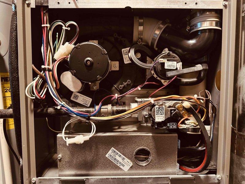Performed preventative maintenance inspection on 2-year-old gas furnace located in basement as part of MVP customer program. Removed access panels to conduct thorough visual inspection of all internal components, including blower motor assembly, inducer motor, gas valve, and control board. Verified proper operation of all electrical connections and wiring harnesses, noting organized wire routing throughout unit. Inspected circuit board for signs of wear or damage, confirmed all terminal connections secure. Documented equipment condition through photography showing clean internal compartment with all components functioning within normal parameters.