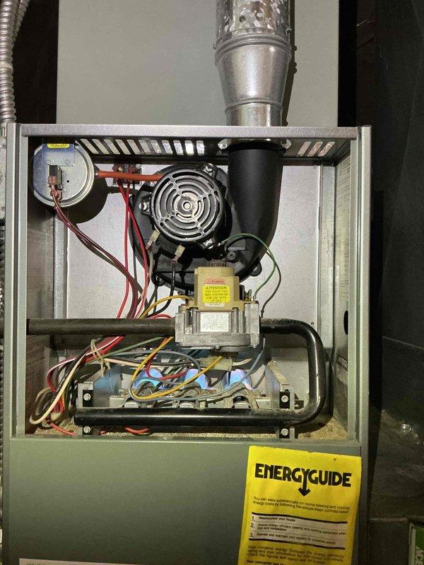 Completed scheduled maintenance visit on 2-year-old air conditioning system as part of recurring MVP cooling service program. Performed comprehensive inspection of HVAC unit including blower motor assembly, gas valve components, burner assembly, heat exchanger, and all electrical connections. Verified proper operation of draft inducer motor, checked all wire connections throughout the system, and inspected control board functionality. Documented equipment condition with interior component photography showing blower motor, gas valve with safety labeling, ignition components, and overall system configuration. All components found in functional condition with proper wiring organization and no immediate service needs identified. System operational and ready for continued use.