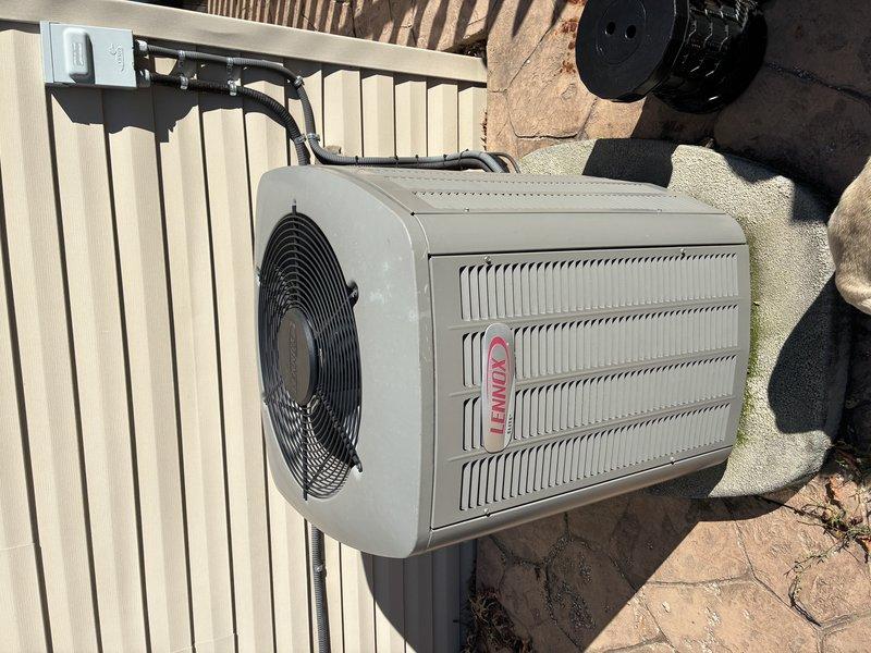 Completed routine HVAC maintenance visit for MVP customer's Lennox condensing unit. Performed system inspection, accessed electrical components and wiring connections, documented unit condition with exterior and interior photographs showing proper installation on concrete pad with all safety controls and capacitor in place.