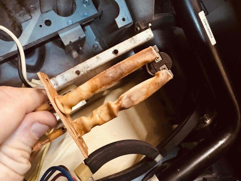 Completed AC tune-up for maintenance plan customer. During inspection, discovered severely corroded burner assembly with heavy rust accumulation on all three burner tubes, requiring replacement for safe operation. Additionally documented dusty conditions in ductwork system during visual inspection.