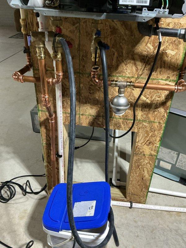 Performed annual maintenance and descaling service on tankless water heating unit. Isolated unit from water supply using installed service valves and connected descaling pump with circulation hoses to flush system. Circulated food-grade descaling solution through heat exchanger for recommended duration to remove mineral buildup and calcium deposits. Flushed system thoroughly with clean water to remove all descaling solution residue. Inspected internal components, heat exchanger condition, and verified proper operation of all connections. Reinstalled access panels and restored unit to normal operation. System tested and confirmed to be functioning within manufacturer specifications.