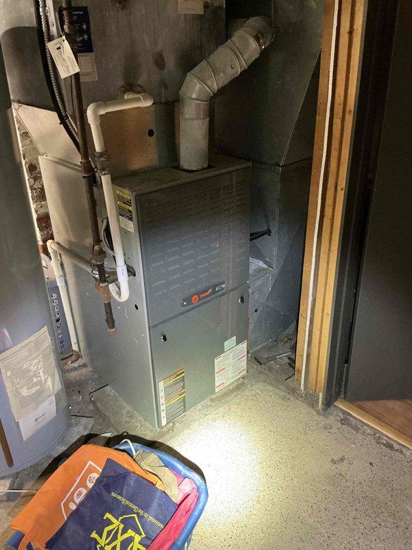 Responded to service call for air conditioning system with reported refrigerant leak. Performed comprehensive diagnostic evaluation of existing Trane furnace and dual outdoor condenser units installed on brick paver pad adjacent to residence. Assessment revealed active refrigerant leak in AC system requiring repair, humidifier component needing replacement, and potential furnace issues warranting further evaluation. Provided detailed estimate for complete HVAC system replacement including new furnace, air conditioning equipment, and associated components to address multiple system deficiencies and ensure reliable climate control operation.
