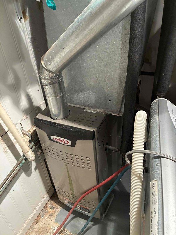 Completed heating maintenance tune-up on 8-year-old Lennox gas furnace located in first-floor laundry room. Performed comprehensive inspection of unit including burner assembly, heat exchanger, ignition system, and ECM blower motor control board. Verified proper operation of hot surface igniter, gas valve, and flame sensor. Checked all electrical connections and wiring harness integrity on control boards. Inspected condensate drain lines and PVC vent piping for proper drainage and clearances. Tested system startup sequence and confirmed furnace cycled properly through all operational stages. Measured temperature rise across heat exchanger and verified within manufacturer specifications. All components found operating within normal parameters with no immediate service needs identified.
