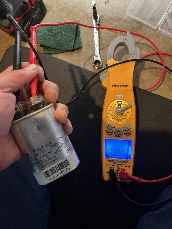 Completed scheduled maintenance on 13-year-old gas heating system. Performed electrical diagnostics using clamp meter to verify proper amperage draw and tested capacitor functionality, which measured 76.53 microfarads and within acceptable operating range. All components inspected and system operating normally with no immediate service needs identified.