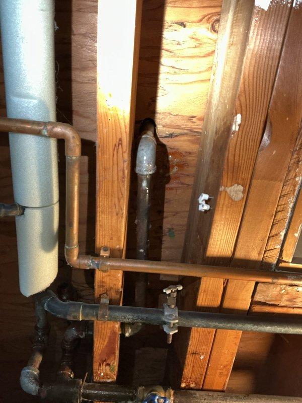 Responded to gas leak call in basement area. Upon inspection, located active gas leak in exposed piping system near water heater installation. Performed pressure test on gas lines to verify leak location and ensure system integrity. Documented existing conditions including 40-gallon natural gas water heater (34,000 BTU input) manufactured in 2018, along with surrounding copper plumbing infrastructure and structural components. Identified compromised connection points requiring immediate attention to restore safe operation of gas system.