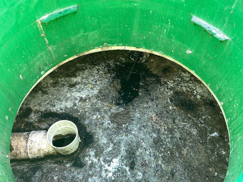 Responded to main drain clog causing water backup in basement. Upon inspection, located heavily corroded floor drain with significant mineral buildup and deterioration at the main drain exit point. Accessed main cleanout assembly, which showed extensive staining and biological growth indicating chronic drainage issues. Cleared blockage from main drain line, restoring proper flow and eliminating standing water condition in basement.