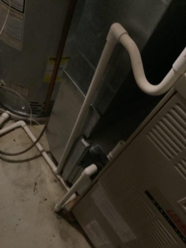 Conducted on-site evaluation of existing HVAC system for replacement estimate at a two-story, 1800 square foot residential property with basement installation. Assessed 23-year-old furnace unit located in basement and 23-year-old air conditioning condenser positioned on exterior concrete pad. Documented current equipment configuration including PVC venting arrangement on furnace and refrigerant line routing on outdoor unit. Photographed both components to support replacement recommendations for aging system that has reached end of typical service life expectancy.